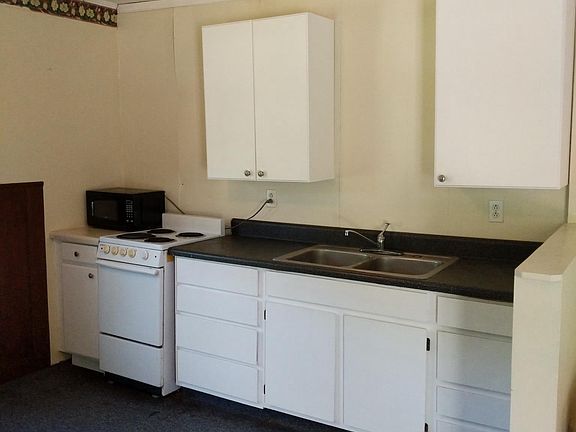 Large kitchen with some new cabinets, and oven and refrigera