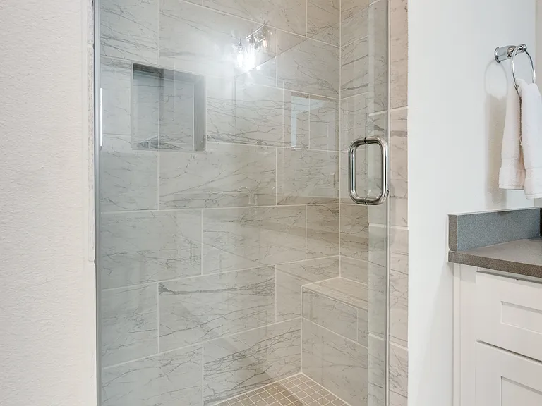 Master bathroom: walk-in shower with bench.