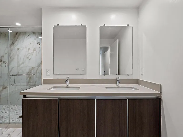 Bathroom with Double-Sink Vanity and Walk-In Shower with Glass Door