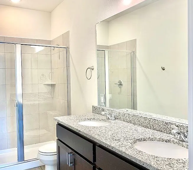 On suite bathroom has double vanity and granite countertops