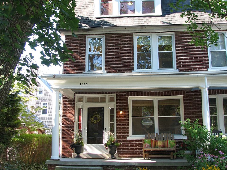 Classy all-brick exterior, lg. porch, stately columns, perennials&stone wall. 