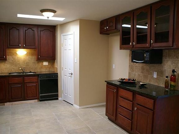 Kitchen, on both sides of microwave are wine glass and bottle holders