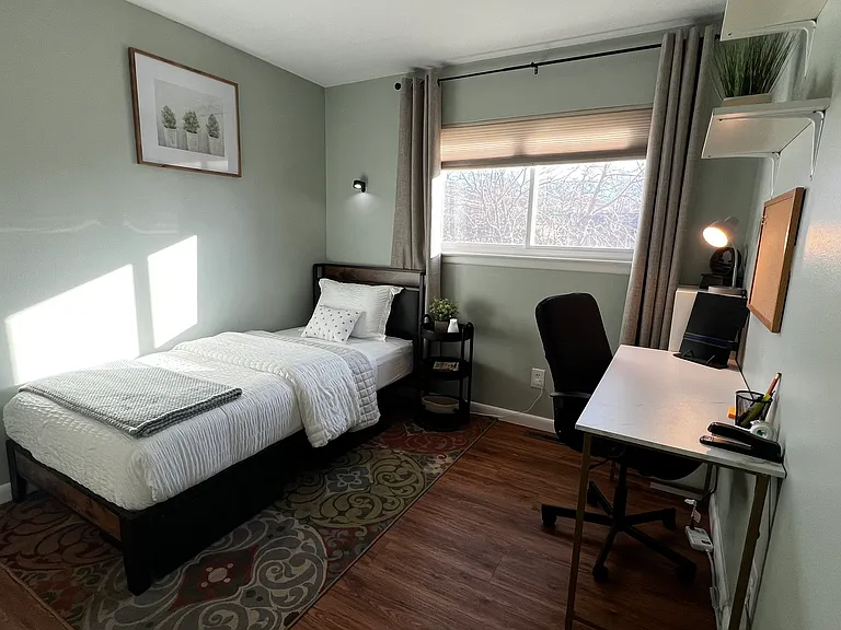 Quiet bedroom with a Twin XL bed and dedicated workspace, ideal for remote work or study.