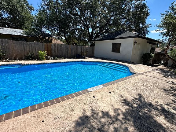 Backyard Pool and Detached Garage which could be a game house / storage area , work shop or separate covered parking garage .