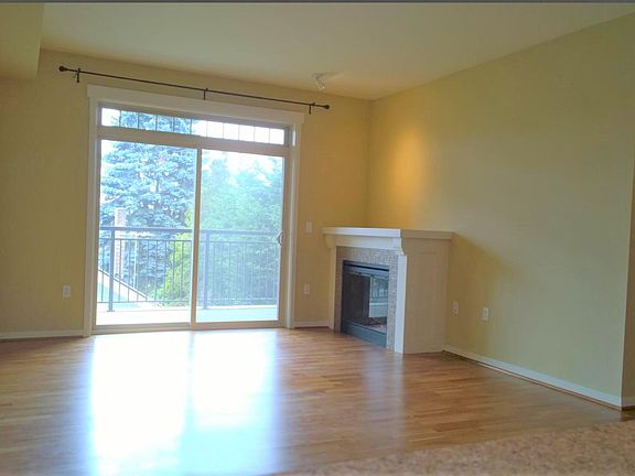 Main room view from kitchen. Bedroom entryway visible on the right.
