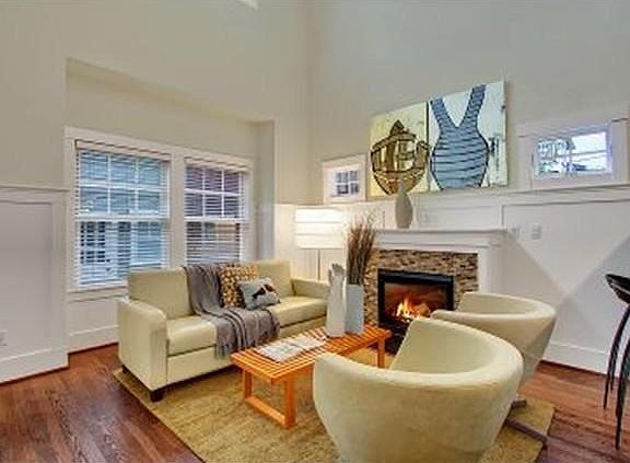 Living room with gas fireplace. 20 ft ceilings in living room. Primary Bedroom and bath are upstairs in a loft overlooking the living room.