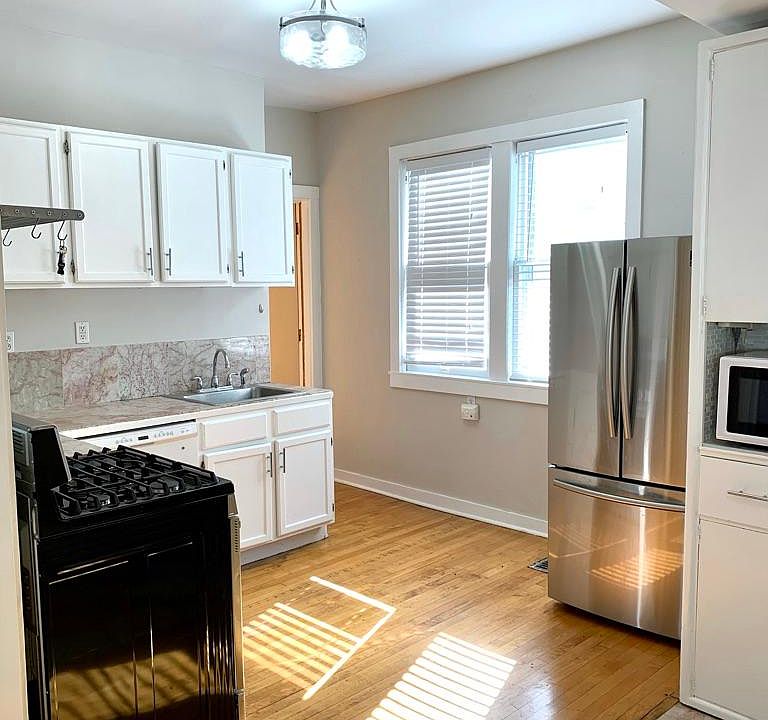 Updated kitchen features a gas stainless range & French door fridge along with a dishwasher & updated lighting.