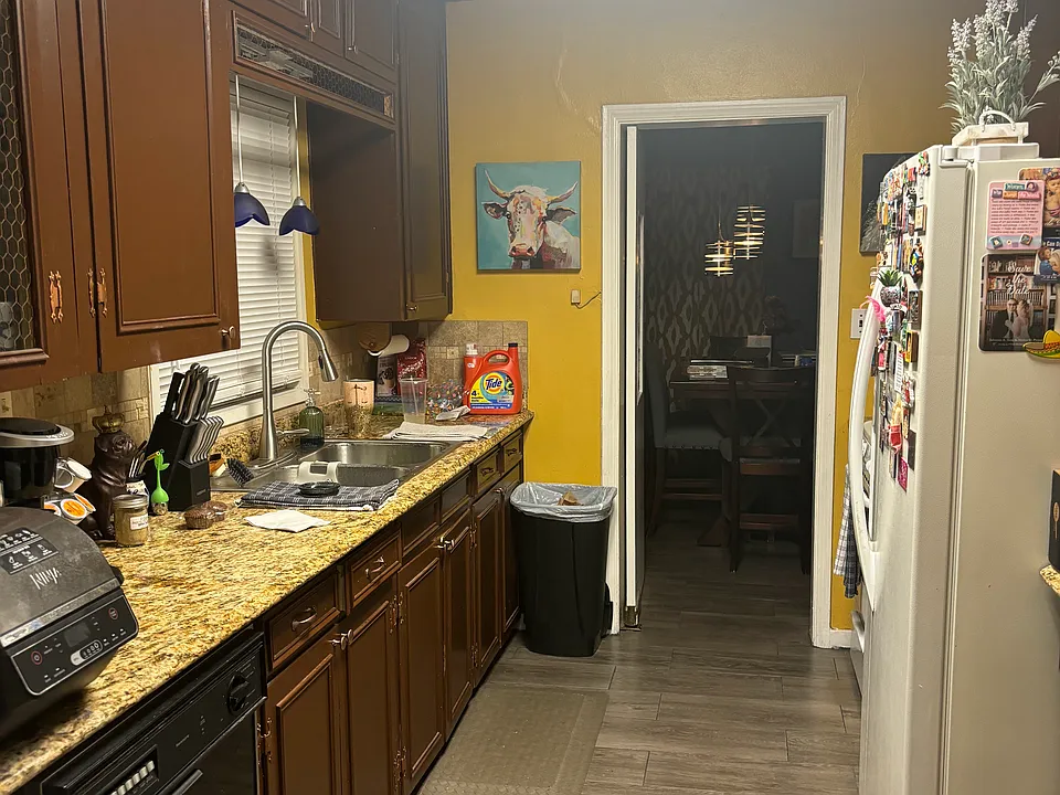 Galley kitchen with fridge, stove, microwave, and dishwasher