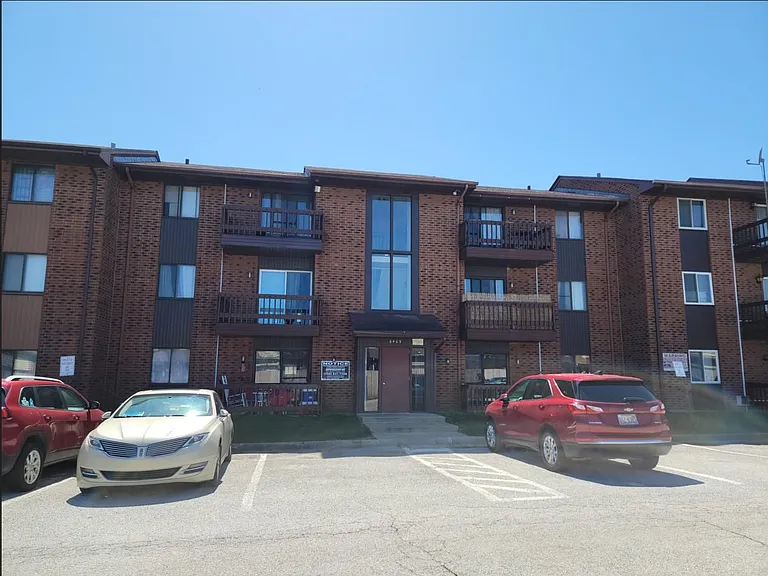 Main elevation (North facing), apt is just behind red color.