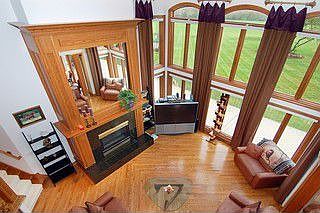 2 story great room boasts floor to ceiling windows and fireplace.