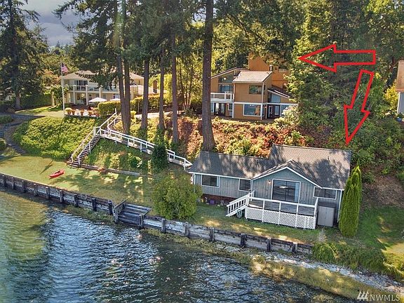 Expansive 116ft bulkhead water front, with gray Beach cottage directly on bulkhead and cedar color main home behind. Two lots in this sale. 1: has to homes, 2: is vacant lot.
