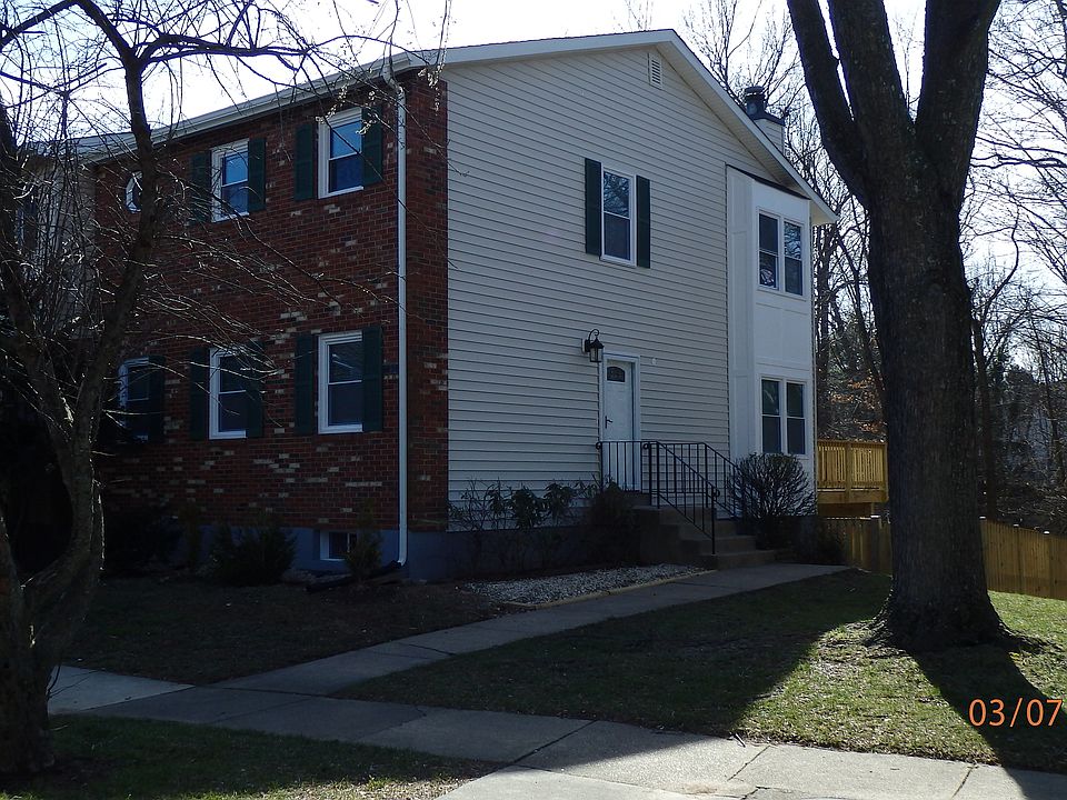 Front and side view showing entry door and bay windows
