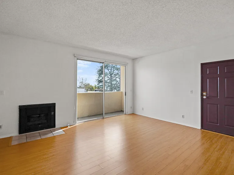 Front Entrance and Living Room Area with Fireplace and Balcony