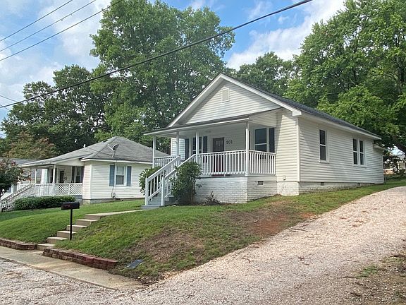 Right side of home showing parking for 4