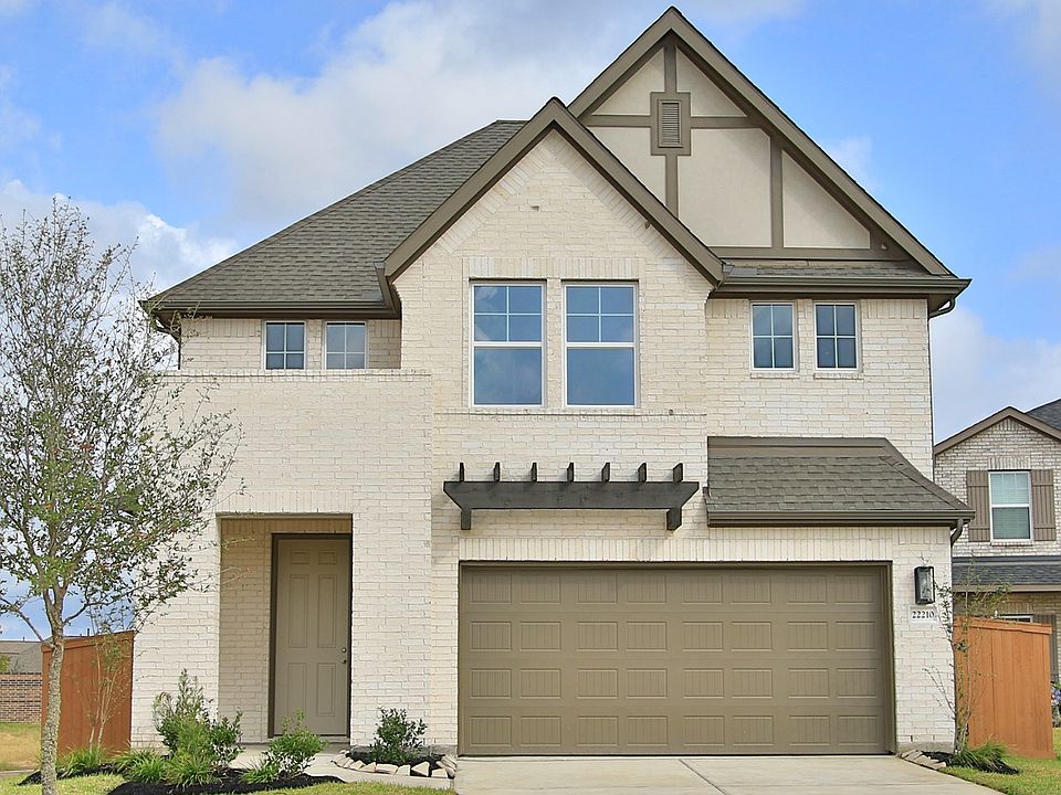 Elegantly designed brick facade with gabled roof and wooden accents in Cypress Green. Luxurious, mod