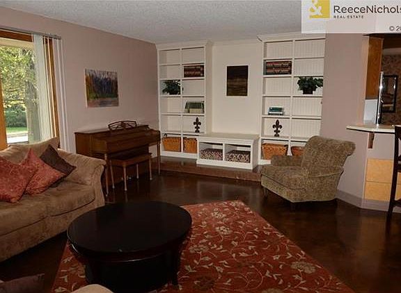 Living room with custom built-in shelves and TV stage.