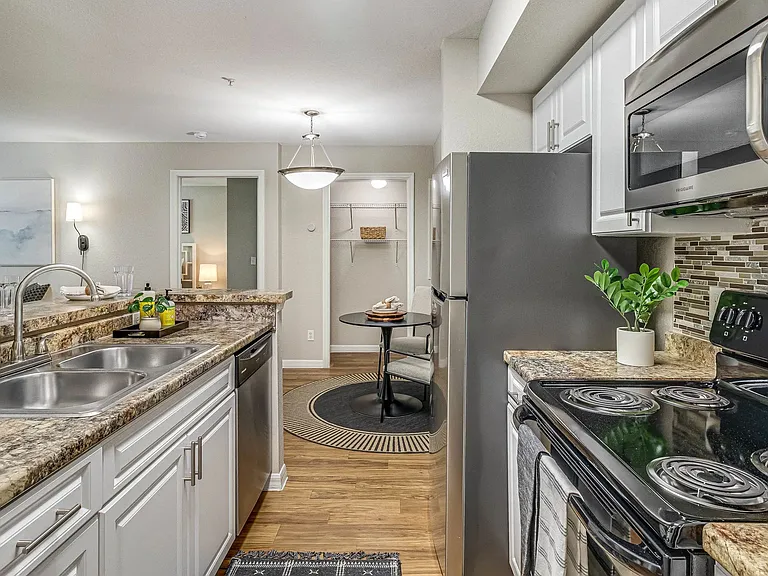 Experience top-of-the-line stainless-steel appliances in a remodeled kitchen with breakfast bar.