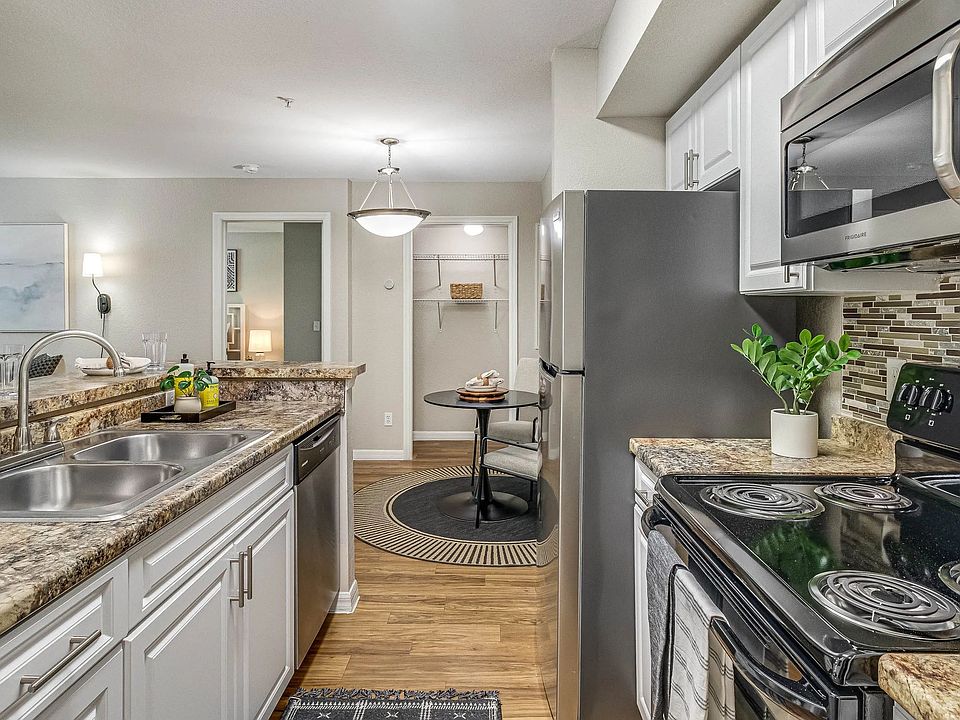 Experience top-of-the-line stainless-steel appliances in a remodeled kitchen with breakfast bar.