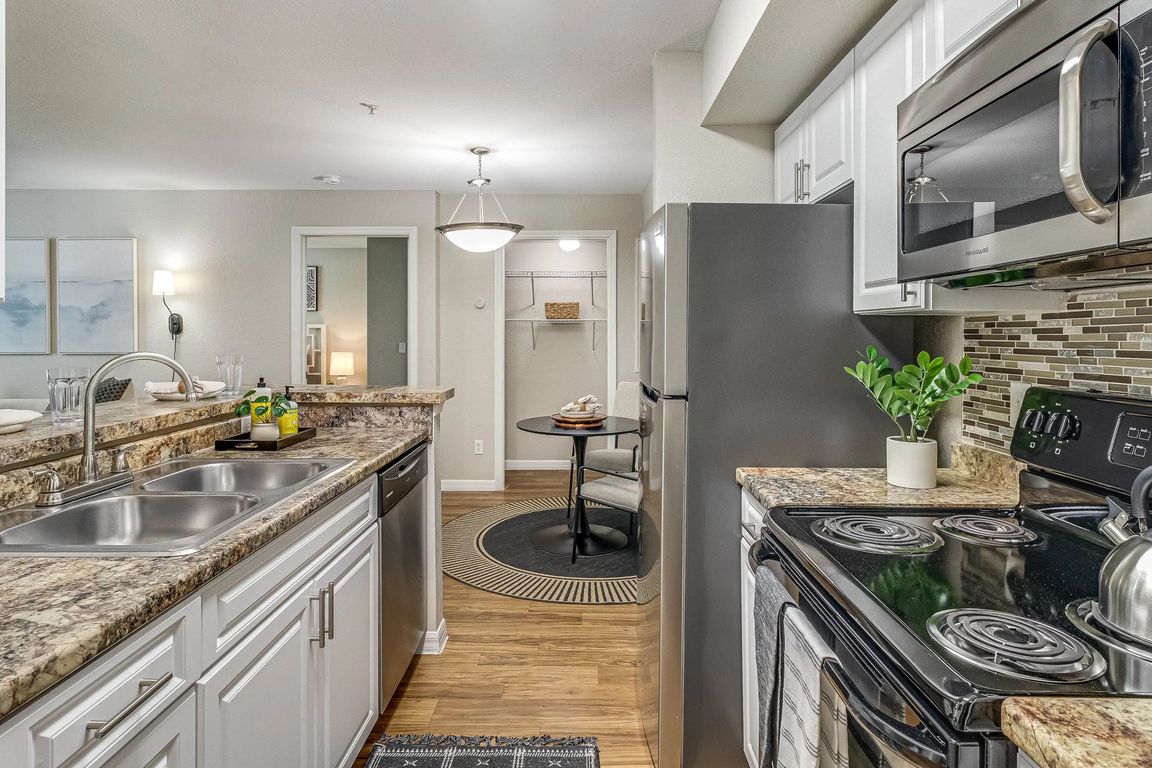 Experience top-of-the-line stainless-steel appliances in a remodeled kitchen with breakfast bar.