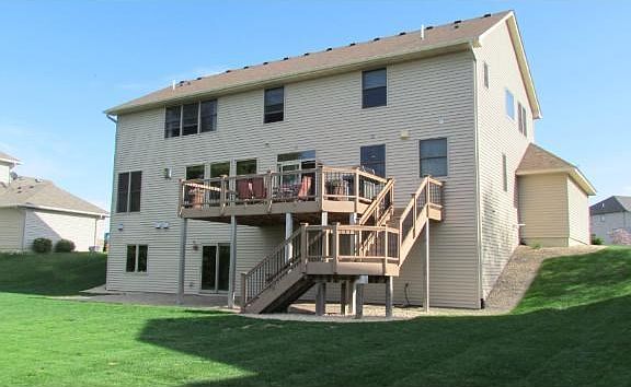 Maintenance free 20 x 14 deck ($24,000) wired for sound system. Invisible fencing for dogs. ($1000) Installed gutter & tile system ($1000) tied gutters  and sump into tiling.
Replace lawn completely with new sod ($2500) New Paver Patio $8000.