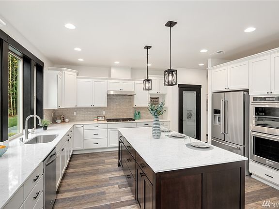 5 burner gas cooktop, walk in pantry, stainless appliances including double convection wall oven.