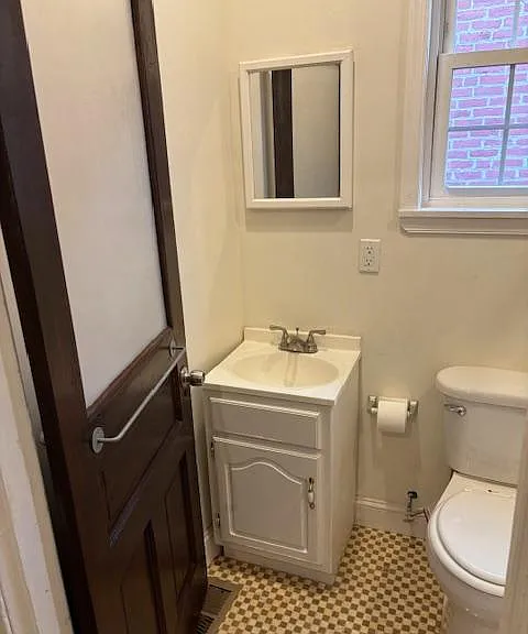 Second floor full bathroom with original frosted glass door.
