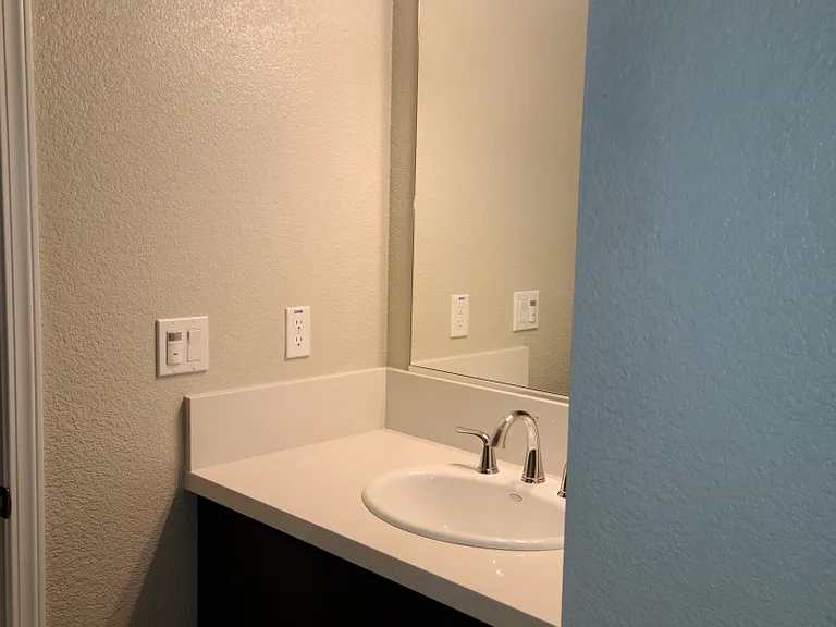 Inside view of the half bath. it doesn't show in this picture, but above the sink is a cathedral style ceiling.