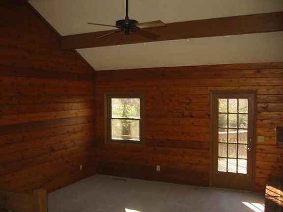 Wood walls that face the brick fireplace.