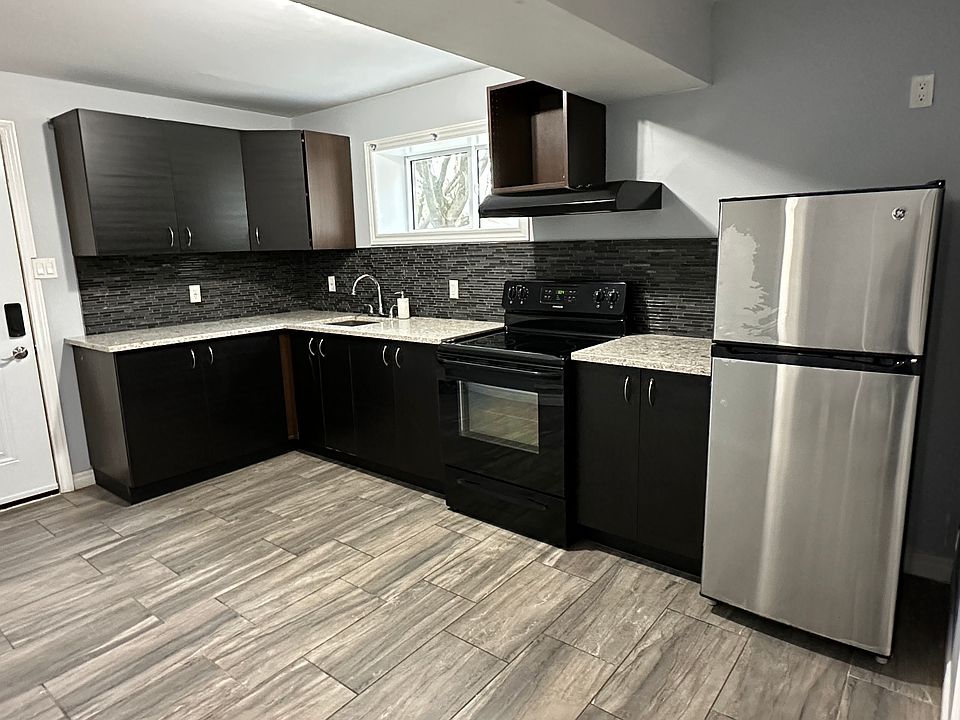 Full open concept kitchen with granite countertops, ample cabinet space and additional storage room.