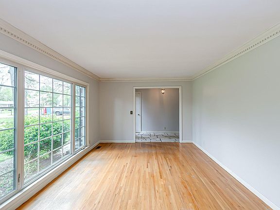 Living room with large windows and hardwood floors