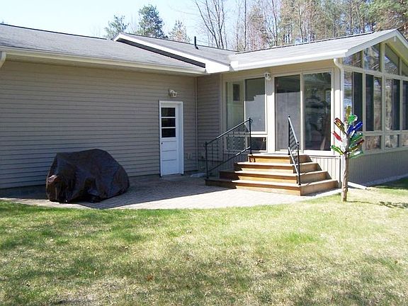 Sliding door off the sun room leads to a paver brick patio.