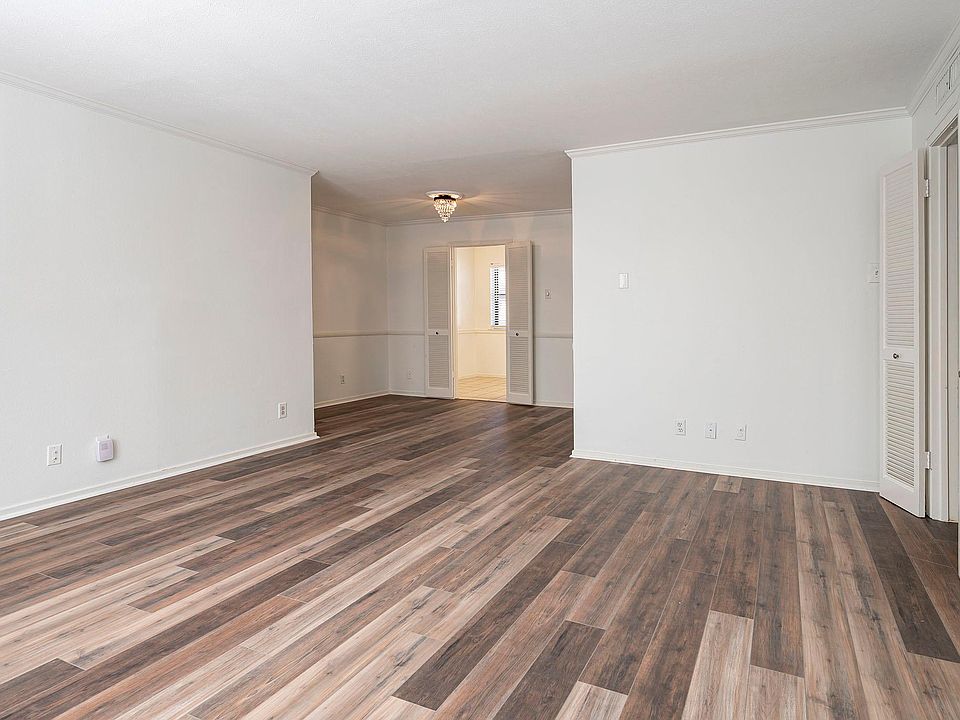 Living and dining room with crown molding and engineered hardwood floors