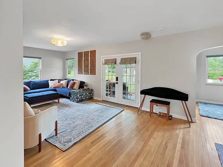 French doors lead outside to front porch and garden area.