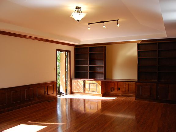 North wall of main room with bookshelves and built in storage cabinets.