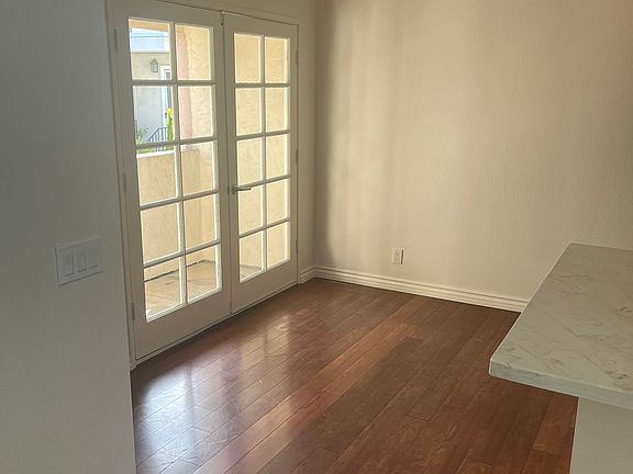 View of dining nook and private balcony from living room