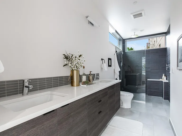 Dual sink vanities + rain shower + mirrors + bidet