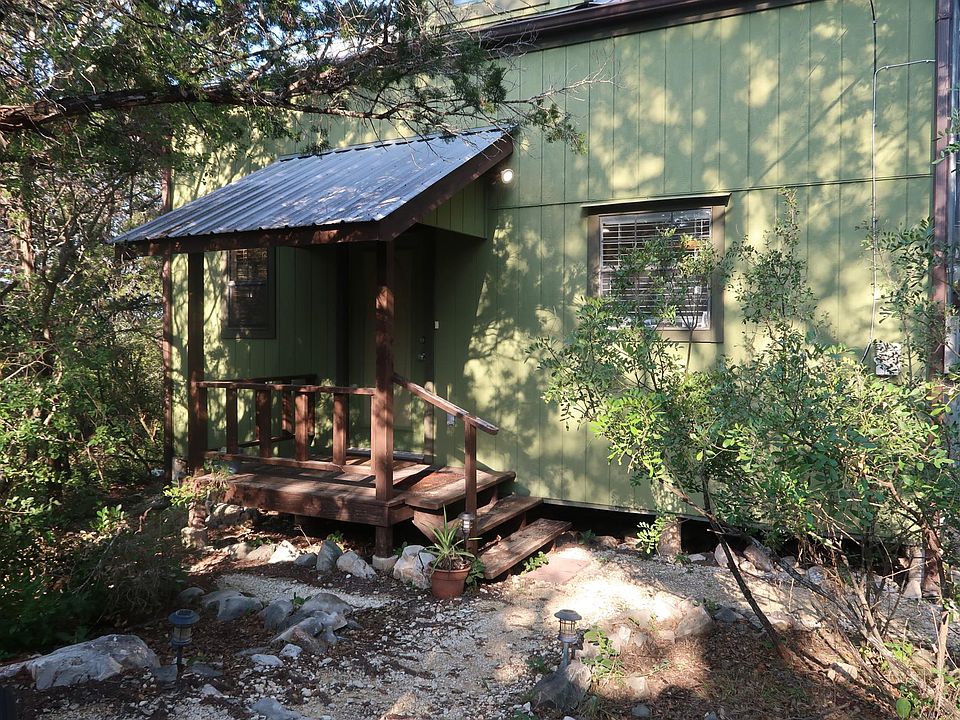 Front porch entrance with gravel walkway.