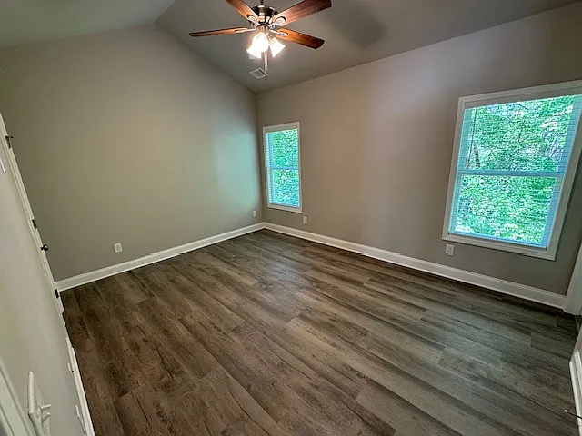 Primary Bedroom with windows overlooking wooded backyard