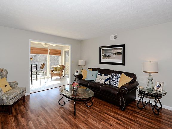 Welcoming living space is open to dining area and sunroom.