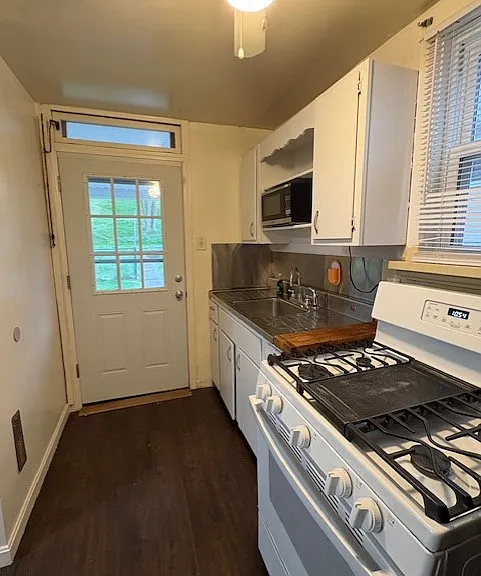 Galley kitchen with gas stove & refrigerator