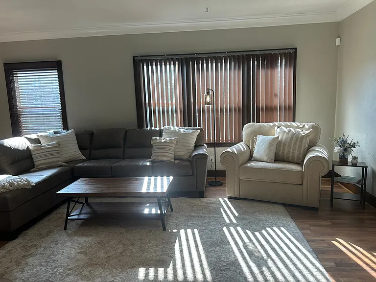 Additional view of the living room with blinds open.