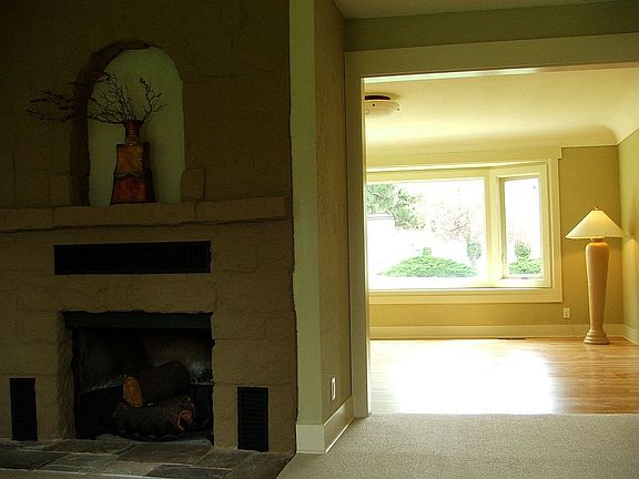 Fireplace with a glance of the living room