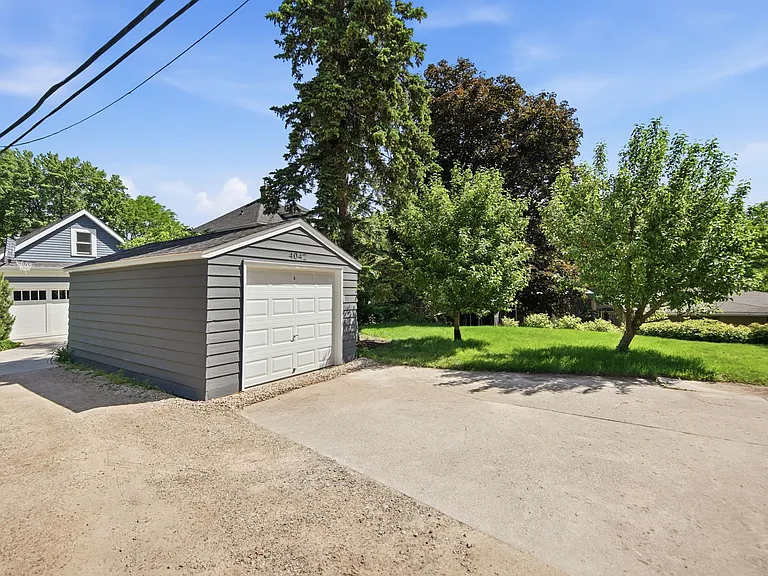 View of back yard from private back driveway (note: this rear garage is for use by the lower-level duplex tenant)