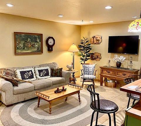 living room. different rug different art. Its a beautiful sunny room in the afternoon and looks out to side yard and grassed front yard