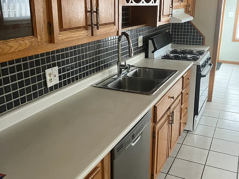 Kitchen with stove, fridge snd dishwasher
