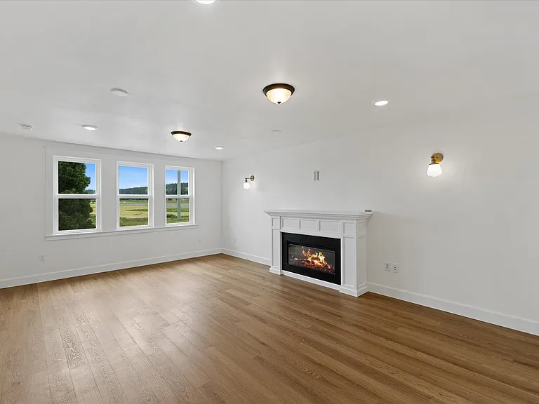Gorgeous electric fireplace graced with sconces. Most of the main level lights are on dimmer switches.