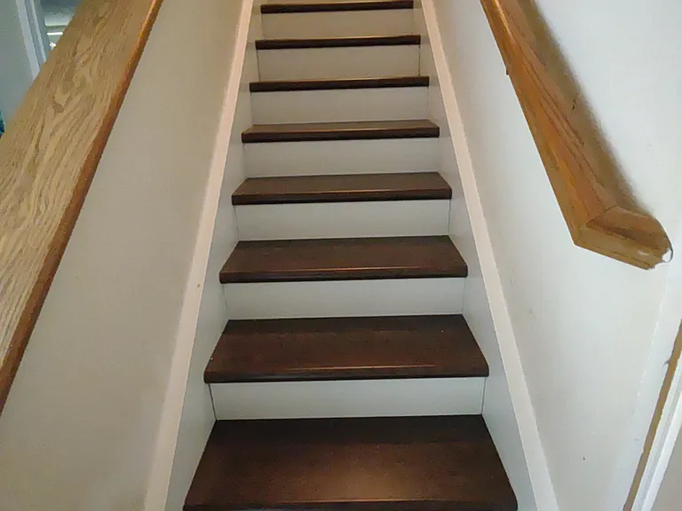 Stairs from bedrooms to the living room and kitchen above.