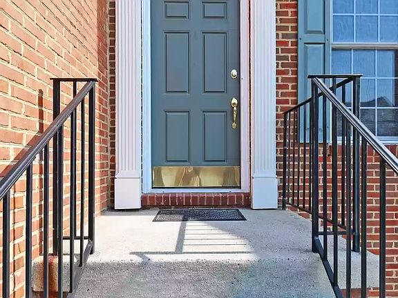 Entry door to the home - with a red brick facade.