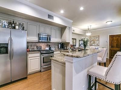 Kitchen features stainless steel appliances and granite countertops.