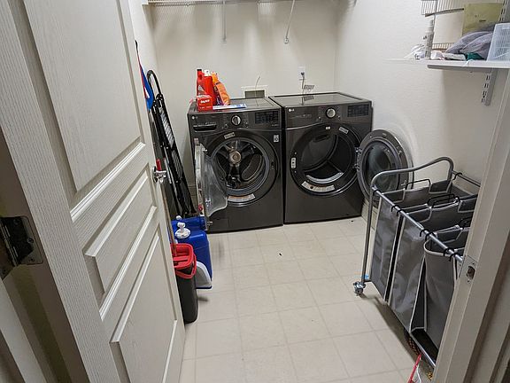 Shared laundry with cleaning supplies and storage